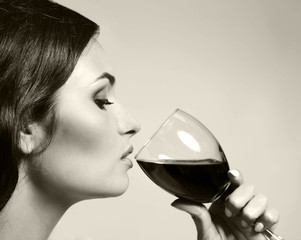 Portrait of beautiful woman drinking wine, black and white retro stylization
