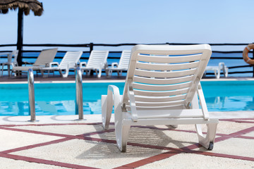 Lounge sunbeds near swimming pool