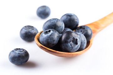 Fresh blueberries in wooden spoon