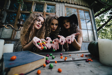 Three vintage witches perform magic ritual
