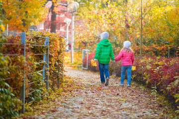 Cute children walking in autumn town