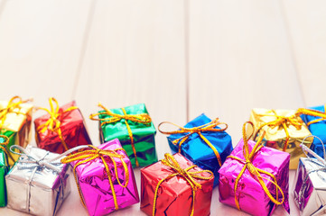 Boxes with gifts on a light wooden boards