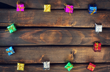 Boxes with gifts on a dark wooden boards