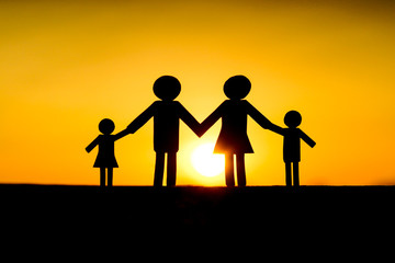 Paper cut of family with sunset background / Family Life Insurance / Protecting family / Family concepts