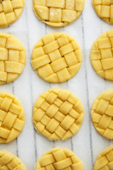 raw Homemade braided Cookies  on a baking sheet