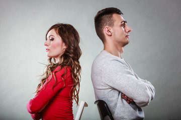Young couple after quarrel sitting back to back