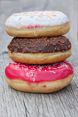 Three colorful donuts facing each other