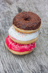 Three colorful donuts facing each other