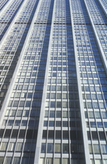 Fototapeta na wymiar Exterior window patterns viewed from street level, Wall Street, NY