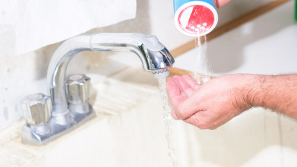 Using garage sink to wash hands with powdered soap