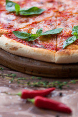 Italian pizza with basil leaves