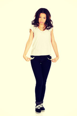 Fototapeta premium Woman showing empty pockets.