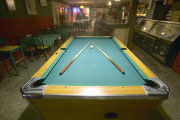 Pool table lit by electric lights in a restaurant and bar in Shoshone, CA near Death Valley National Park