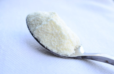 close up of powdered milk and spoon for baby