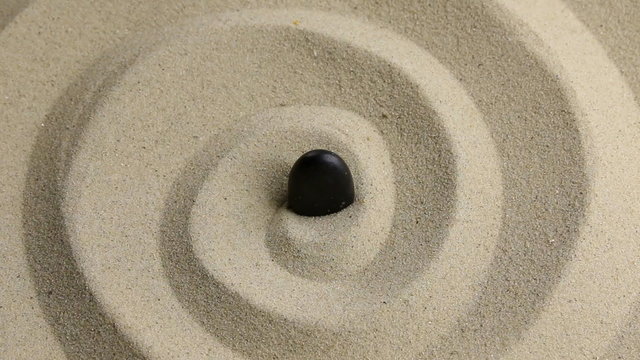 Approximation of black  stone on the sand