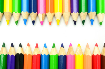 Colorful vertical pencil crayon border over white