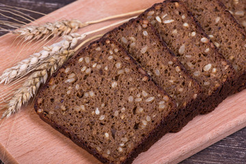 Fresh bread and wheat on the wooden