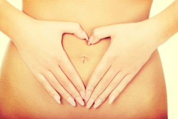 Woman with her hands on belly.