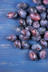 Blue plums on wood