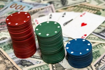 Poker chips with cards on the dollars background