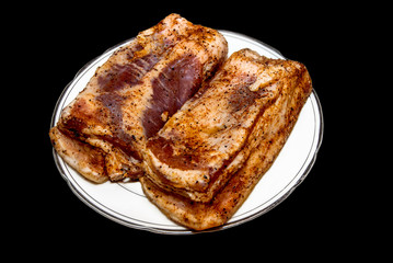 Marinated pork on a black background