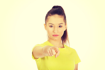 Young woman pointing on you.