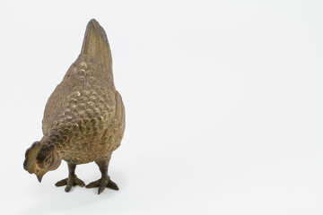 Antique grunge brass chicken sculpture isolated on white backgro