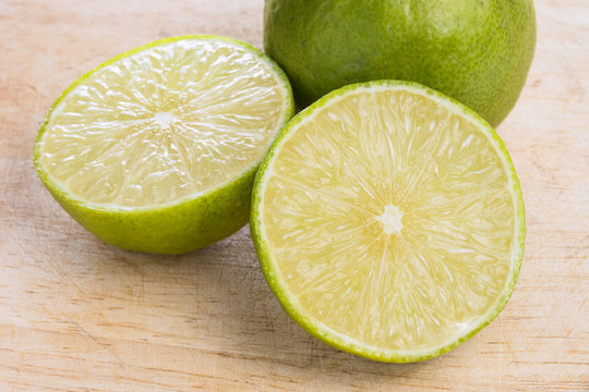 limes on wooden cutting board