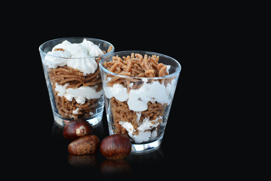 Vermicelles sweet chestnut noodles with whipped cream in glasses on black