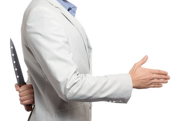 businessman with a knife behind his back