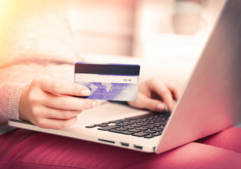 Concept for Internet shopping: hands with laptop and credit card