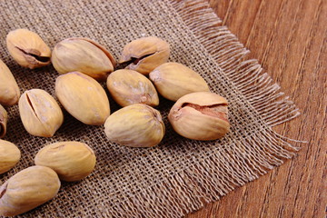 Pistachio nuts on wooden table, healthy eating