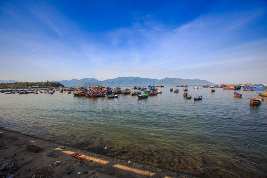 distant group of Vietnamese fishing boats against hilly islands