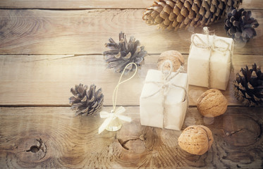 Fototapeta na wymiar toys for the Christmas tree and pine cones on old wooden background
