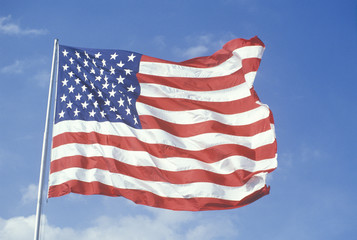 American Flag Flying Against Blue Sky, United States