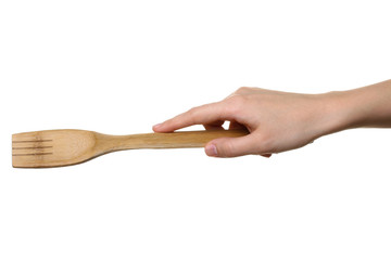 wooden fork in the hand of women isolated on white background