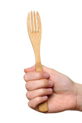 wooden fork in the hand of women isolated on white background