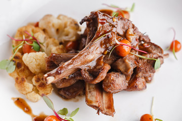 Grilled rack of lamb with vegetables.