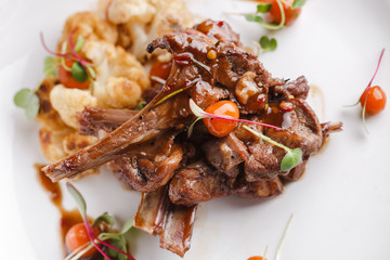 Grilled rack of lamb with vegetables.