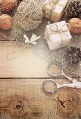 toys for the Christmas tree and pine cones on old wooden background