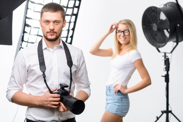 Male young photographer holding a camera