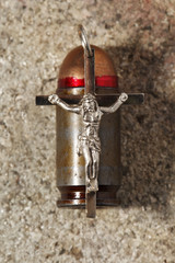 Bullet and pectoral cross , abstract religion