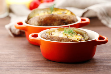 Baked potatoes with cheese and mushrooms on table close up