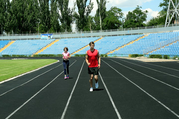 Young people jogging on stadium