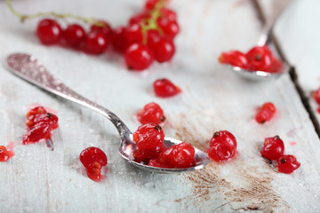 Fresh red currants on wooden table close up