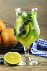 Kiwi and Blueberry cocktail on wooden background