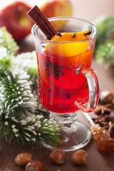 glass of mulled wine with orange and spices, winter drink