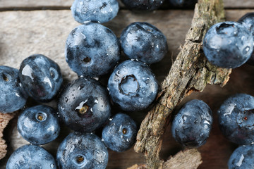 Tasty ripe blueberries on wooden table close up