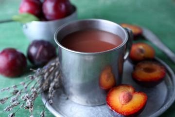 Delicious plum juice with fruits on wooden table close up