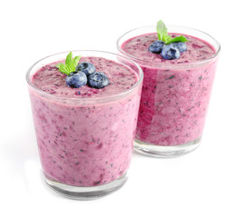 Glass of blueberry smoothie isolated on white